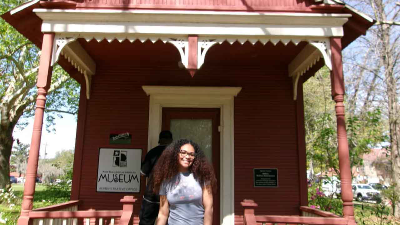 Natasha Bibbs in front of the River Road African American Museum