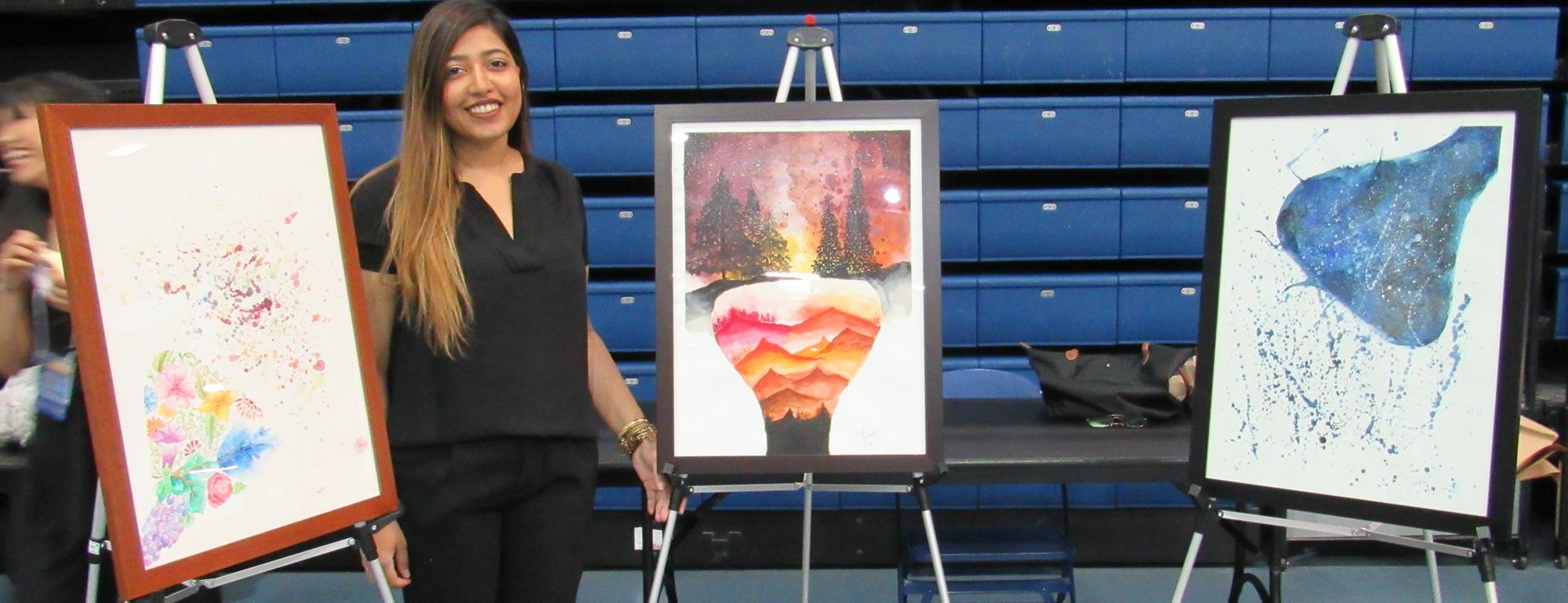 Student in front of three paintings