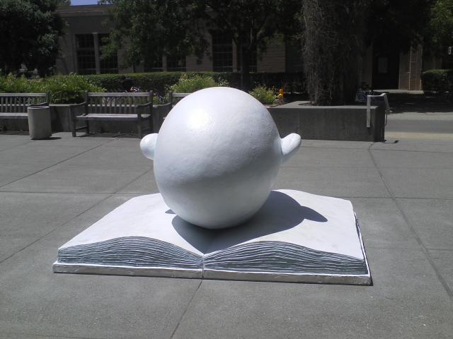 Picture of UC Davis Egghead sculpture of head in book