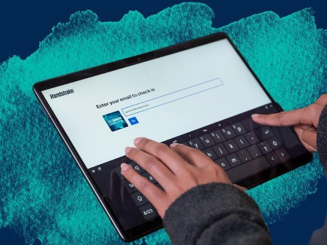 Hands typing on a tablet
