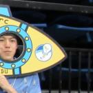 Photo of URC Conference presenters posing with spaceship photo props at the URC Conference